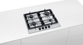 Bosch Gas Hob 4 Burner stainless steel built into white kitchen countertop